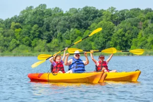 three people in kayaks