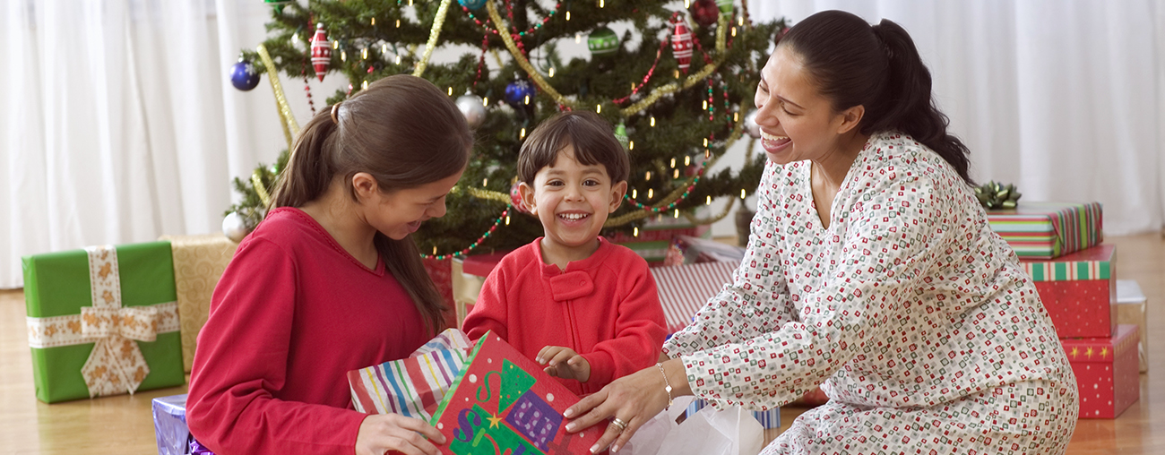 family of 3 with boxes and tree